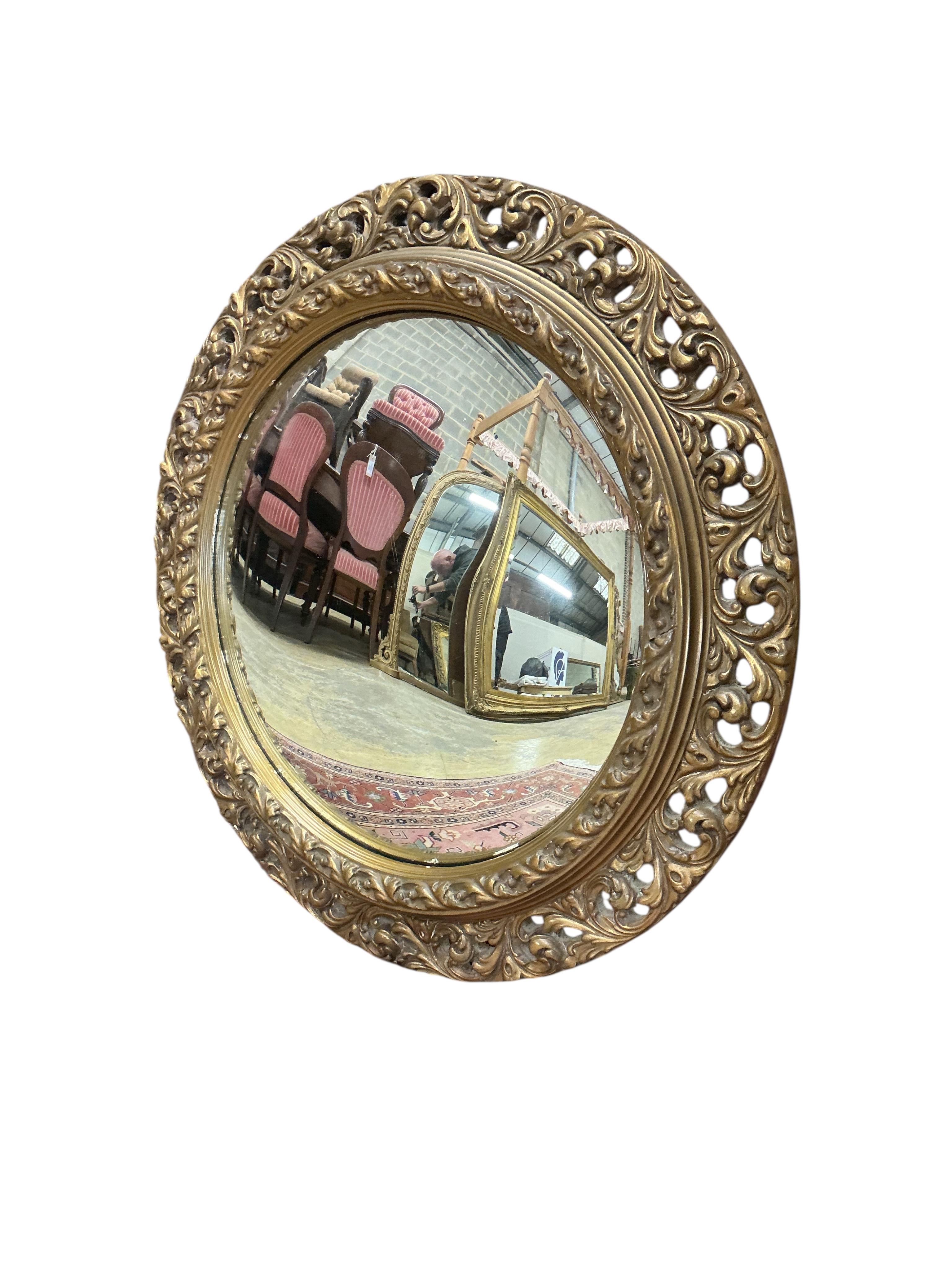An early 20th century giltwood convex wall mirror, diameter 56cm together with one other circular wall mirror